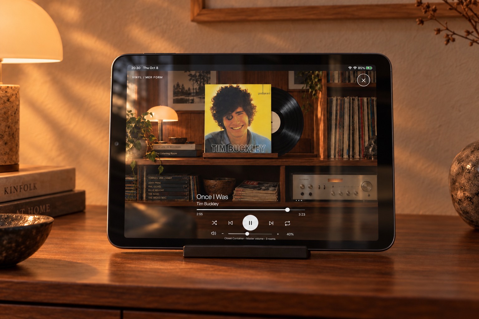 Close-up of an iPad mini displaying Vinyl Mode, Tim Buckley artwork and playback controls on a walnut sideboard.